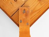 a close up view of a wooden table with a piece of wood sticking out of it