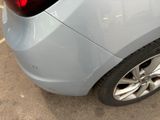 a close up of a car ' s rear end with a red tail light