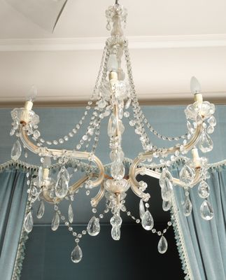a crystal chandelier hanging from a ceiling in a room