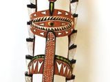 a tall vase that has a bird on top of it