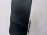 a cell phone that is sitting on top of a stand