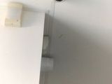 a picture of a bathroom with a toilet and a toilet paper dispenser on the wall