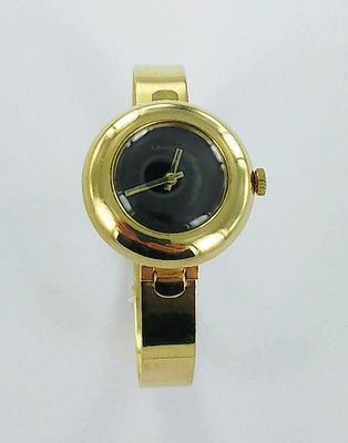 yellow metal watch with black face on a white background