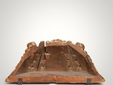 an old wooden tray with carvings on it on a white surface