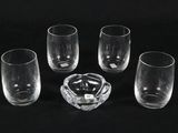 four empty glasses and a ashtray on a black background