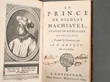 an old book with a picture of a man in a hat on top of it