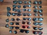 de nombreuses paires de lunettes de soleil posées sur une table en bois