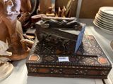 a wooden box sitting on top of a table next to plates