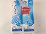 two packets of toothpaste sitting on top of a white table