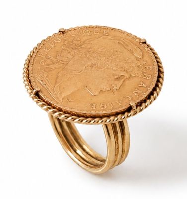 a close up of a ring with a coin on top of it