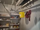 a room with shelves and shelves with shoes hanging on them