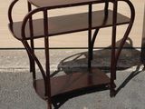 a small wooden table with a shelf on top of it