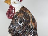 a ceramic rooster that is sitting on top of a table