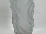 a glass vase sitting on a table with a white background