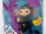 a toy monkey in a plastic package on a table