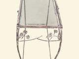 a glass table with a metal frame and flowers on it