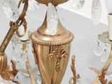 a gold chandelier with crystal beads hanging from it