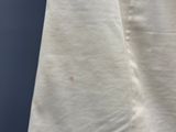 an image of a close up of a white shirt with a small spot on it