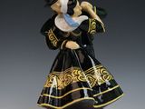 figurine of a woman in a black and gold dress holding a bird