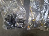 two bags of screws sitting on the floor next to each other