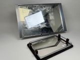 a mirror that is sitting on a table next to a piece of paper