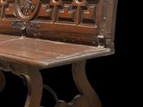 a wooden bench that has a carved design on it