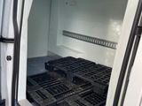 a white van with crates in the back of it
