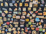 many different types of pins on a black surface