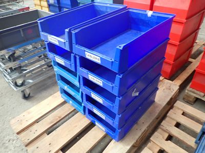a stack of blue and red bins on a pallet