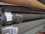 several rolls of fabric are stacked on top of each other in a warehouse