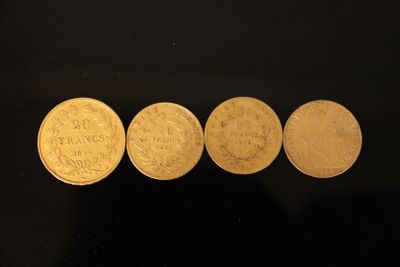 four different types of gold coins on a black surface