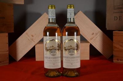 two bottles of wine sitting next to each other on a table