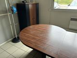 a wooden table with a lamp on it in a room