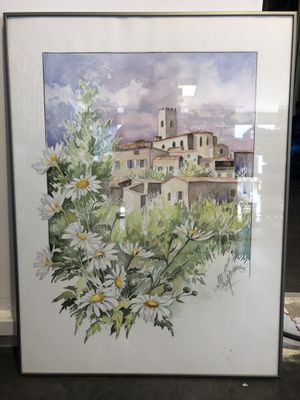 aquarelle encadrée représentant un village avec des marguerites en premier plan