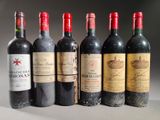 several bottles of wine are lined up on a table