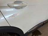a white car with a sticker on the side of it
