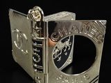 an image of a silver book with a ring on it