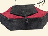 a black purse with a red lining on top of it
