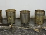 five cups and a spoon sitting on a table