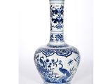 a blue and white vase with a bird on it