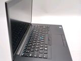 a laptop computer sitting on a table with a keyboard