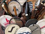 many tennis rackets that are sitting on the floor