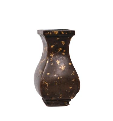 a brown vase with gold paint on it on a white background