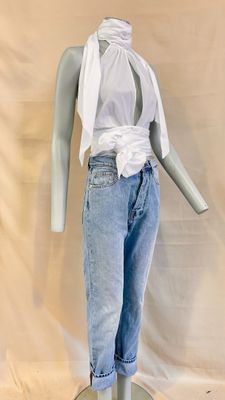 a mannequin wearing a white shirt and jeans on a stand