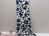 a white and blue dress and a pink and blue dress on a hanger