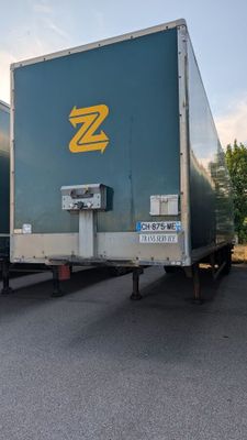 two semi trucks that are parked in a parking lot