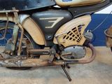 a old motorcycle that is sitting in a garage