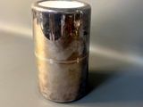 a silver cup that is sitting on a table