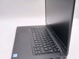 a laptop computer sitting on a table with a keyboard