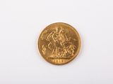 a gold coin on a white surface with a white background